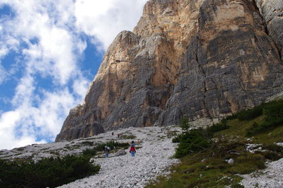 Low angle view of hikers climbing mountain