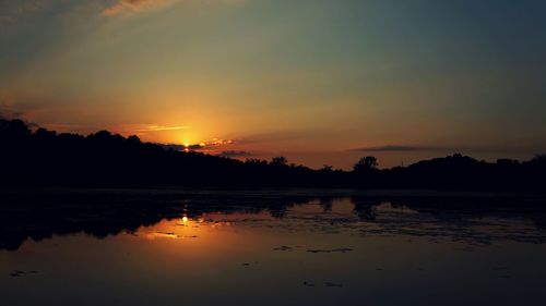 Scenic view of lake at sunset