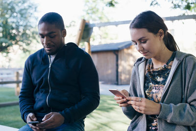 Young multi-ethnic friends using smart phones