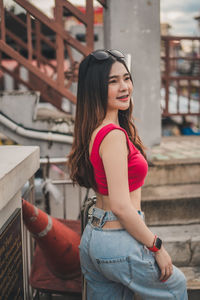 Portrait of young woman standing outdoors