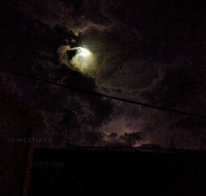 Low angle view of illuminated moon at night