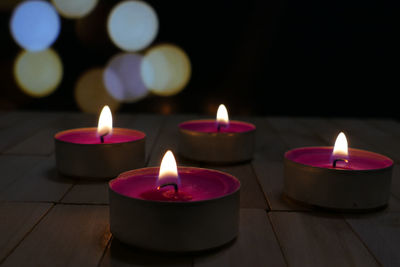 Close-up of lit candles on table