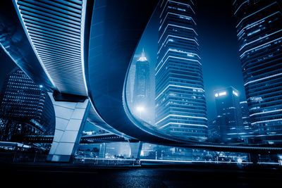 Illuminated modern buildings in city at night