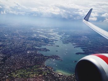 Cropped image of airplane wing over landscape