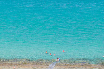 People swimming in sea