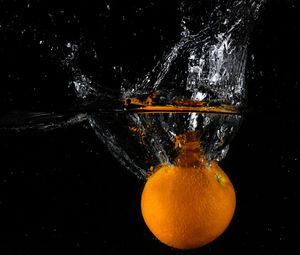 Close-up of water drops on glass against black background