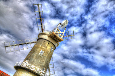 Low angle view of crane against sky