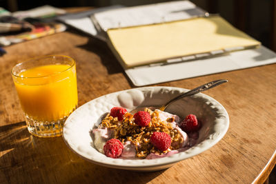 Close-up of breakfast served on wooden table