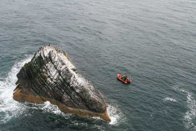 High angle view of red rock in sea