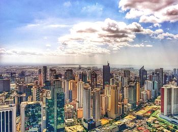 Cityscape against cloudy sky