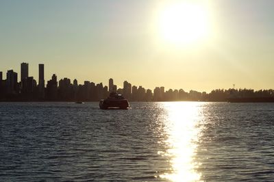 View of city at waterfront during sunset