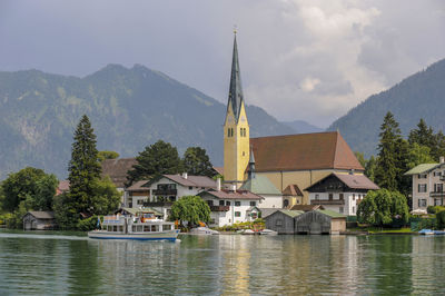 Famous view over lake tegernsee to the church of city rottach-egern