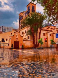 Houses by swimming pool against buildings in city