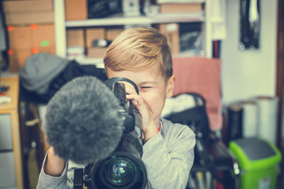 Boy using video camera at home