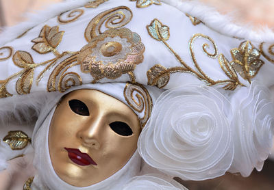 Portrait of woman wearing mask and headdress