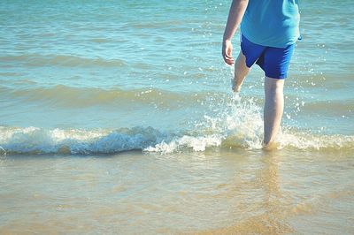 Low section of woman standing on beach