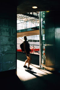 Side view of a woman walking in corridor