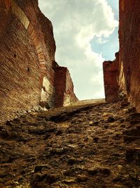 Low angle view of fort against cloudy sky