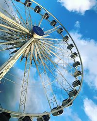 Low angle view of ferris wheel against sky