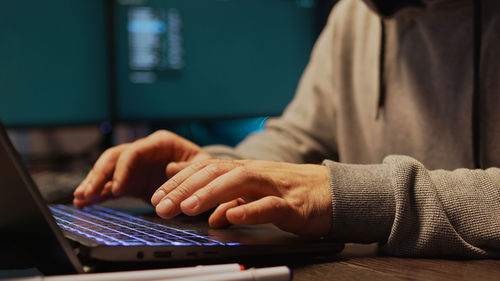 Midsection of woman using laptop