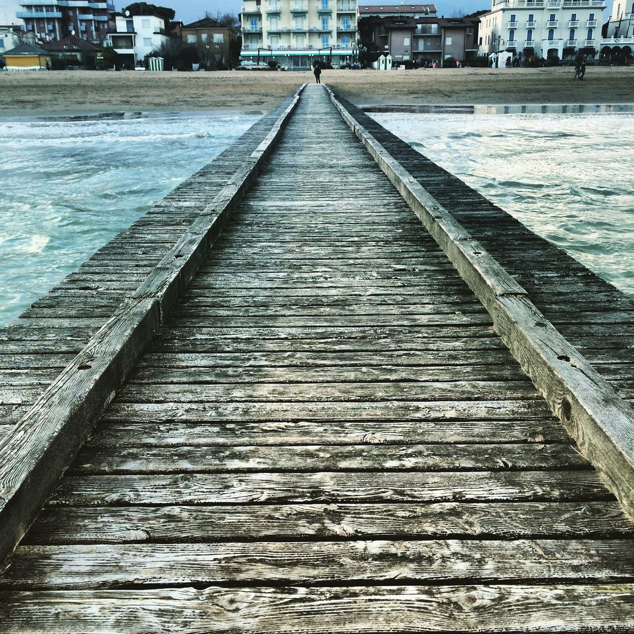 water, built structure, architecture, the way forward, diminishing perspective, river, connection, building exterior, pier, vanishing point, waterfront, transportation, bridge - man made structure, rippled, long, sea, city, day, canal, outdoors