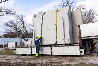 Worker strapping concrete slabs on truck