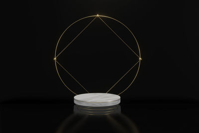 Close-up of illuminated light bulb against black background