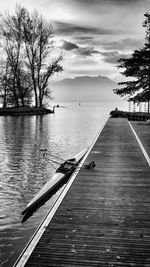 Scenic view of pier over lake against sky