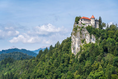 Scenic view of building and mountains against sky