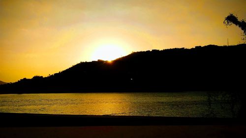 Scenic view of lake against orange sky