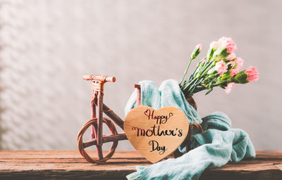 Close-up of bicycle sign on table against wall