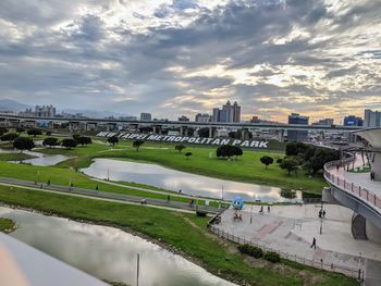 High angle view of river and cityscape against sky