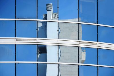 Low angle view of building against blue sky view  in the mirror