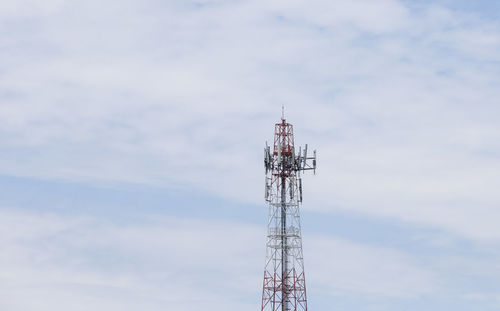 Low angle view of communications tower against sky