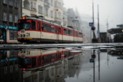 Tram on road along buildings