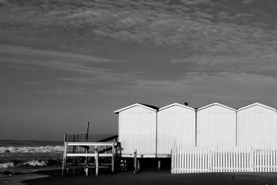 Lifeguard hut at seaside against sky