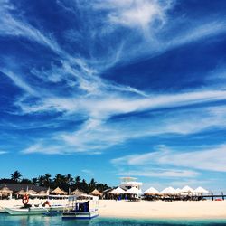 Scenic view of beach against blue sky