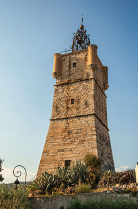 View of the clock tower made of stone at draguignan, in the french provence.