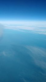 Aerial view of sea against blue sky