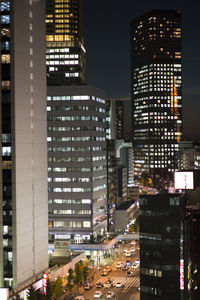 View of skyscrapers lit up at night