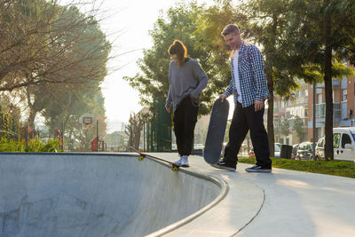 Friends skateboarding in park