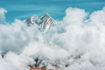 High angle view of airplane flying over sea against sky