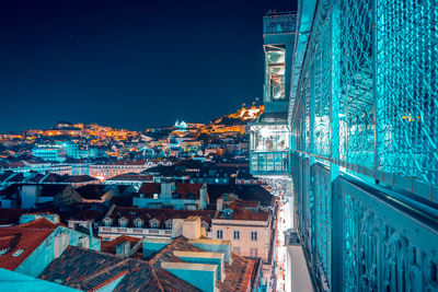 Aerial view of illuminated buildings in city at night