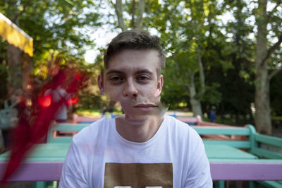 Portrait of young man against trees