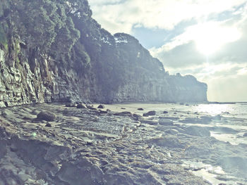 Scenic view of sea and mountains against sky