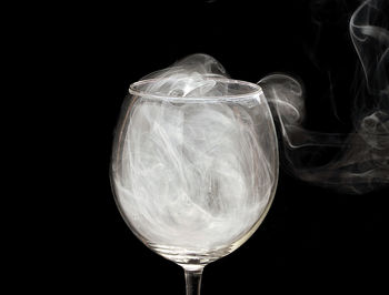 Close-up of smoke emitting from glass