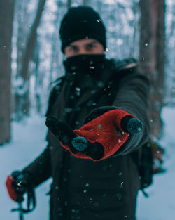 Portrait of man gesturing standing in snow