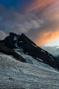 Scenic view of snowcapped mountains against sky during sunset