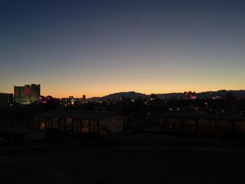 View of illuminated cityscape at sunset