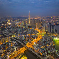 High angle view of city lit up at night